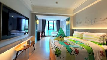 A hotel room with a bed, a desk, a chair, a window, and a view of the outside.