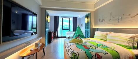 Habitación de hotel con cama, escritorio, silla, ventana y vistas al exterior.