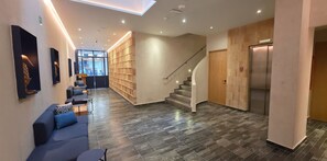 A modern interior with a staircase, a reception desk, and a seating area. - voco Ciudad De Mexico Reforma by IHG (Mexico City)