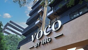 A building with a sign that reads 'VOCO BY IHG.'