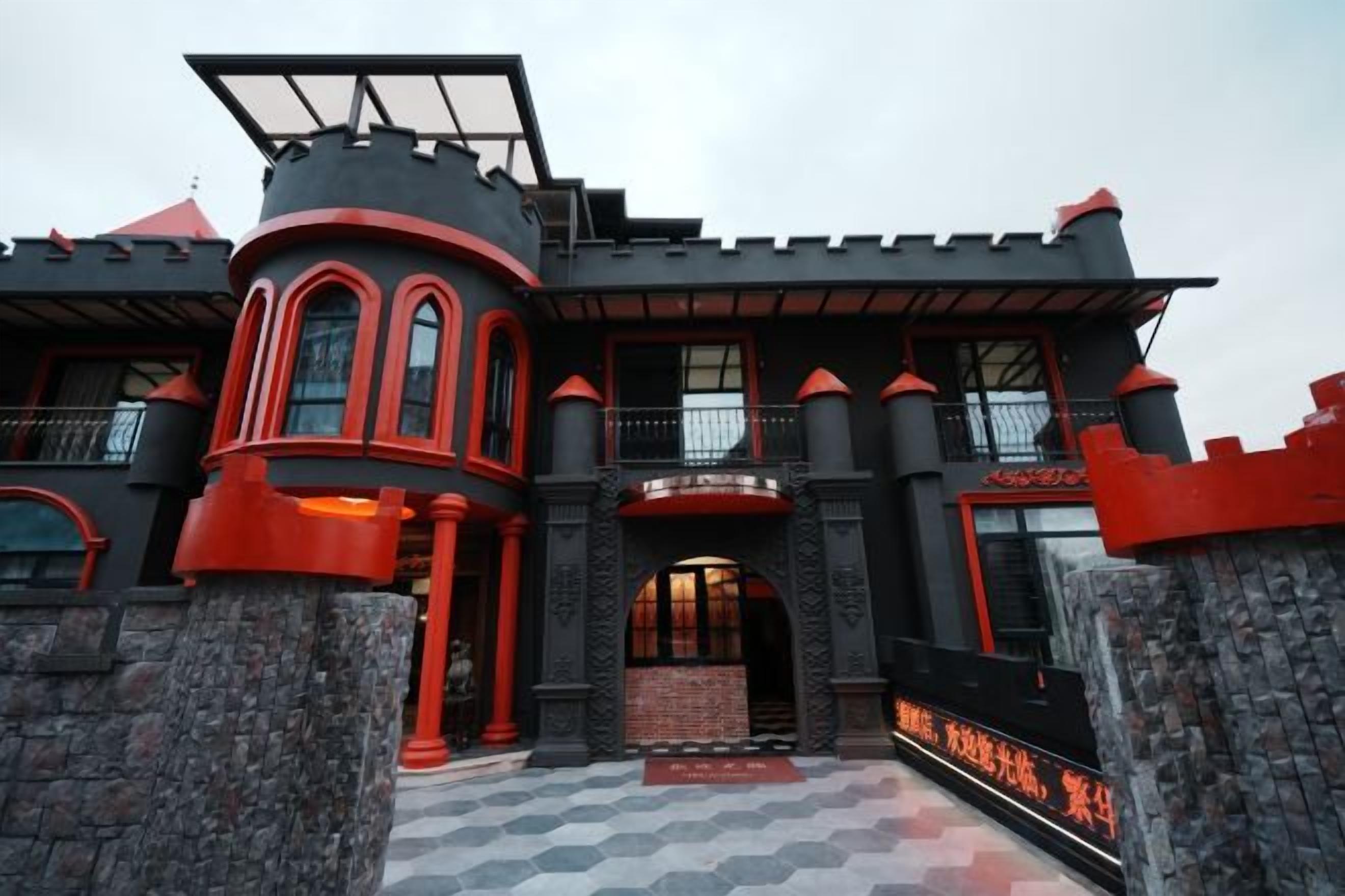 A castle-like building with a central entrance, stone pillars, and a checkered floor pattern.