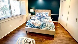 A bedroom with a bed, a nightstand, a window, and a door. - Pacific Dreams at Woodland Hills Distinguished 8 Br 6 5 BA Residence With Pool and Spa Sleeps 16 (Calabasas)