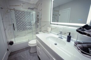 Shower, hair dryer, towels, soap