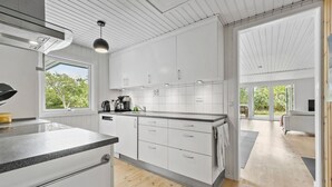 A modern kitchen with white cabinets, a coffee maker, and a view of the outdoors. - Gorgeous home in Sjællands Odde with WiFi (Sjællands Odde)