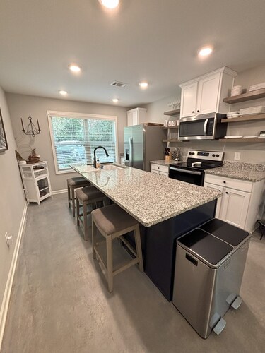 Modern, 3/2 bed with fireplace, screened porch, & outdoor seating area.