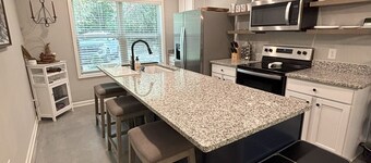 Modern, 3/2 bed with fireplace, screened porch, & outdoor seating area.
