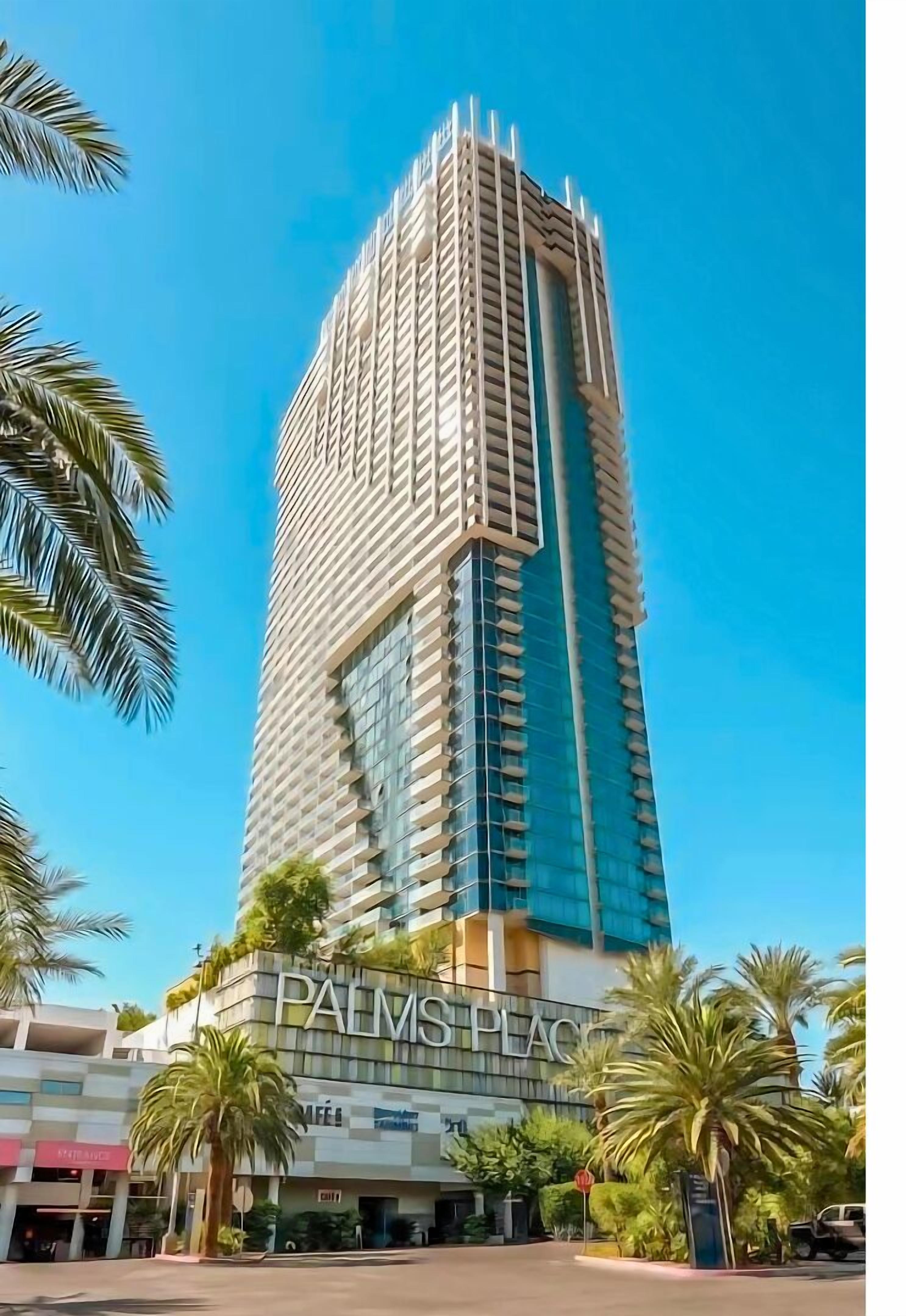 A tall, modern building with the name "PALMS PLACE" on its facade.