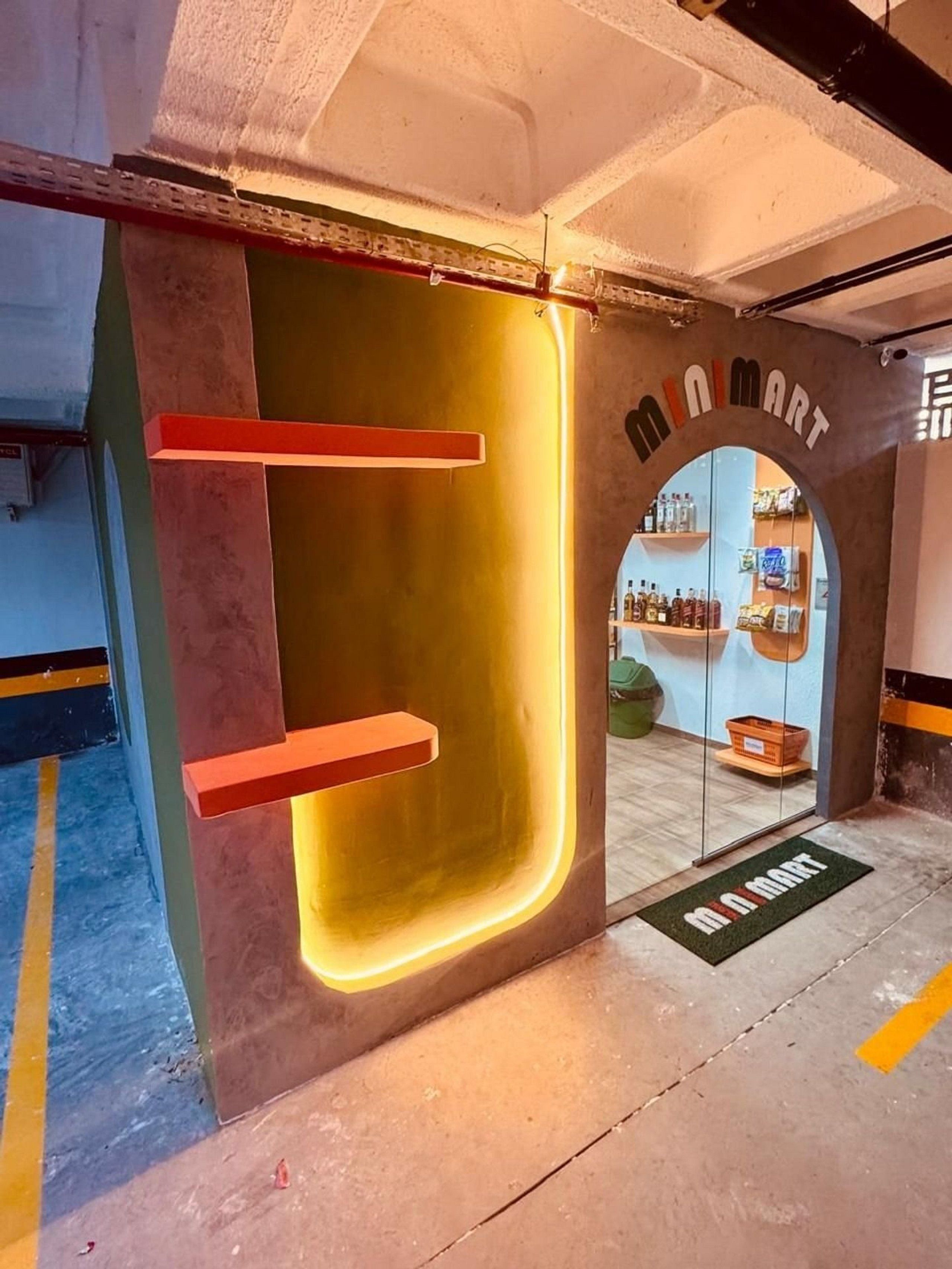 A MiniMart entrance with a modern design, featuring a glass door and a neon sign.