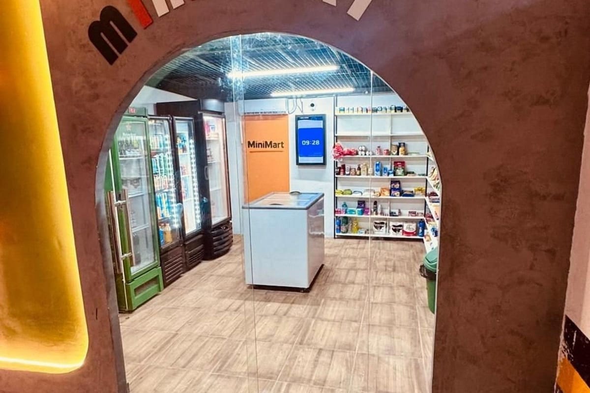 An interior view of a MiniMart store with a clear archway entrance, a digital clock displaying 09:28, and a variety of products on shelves.