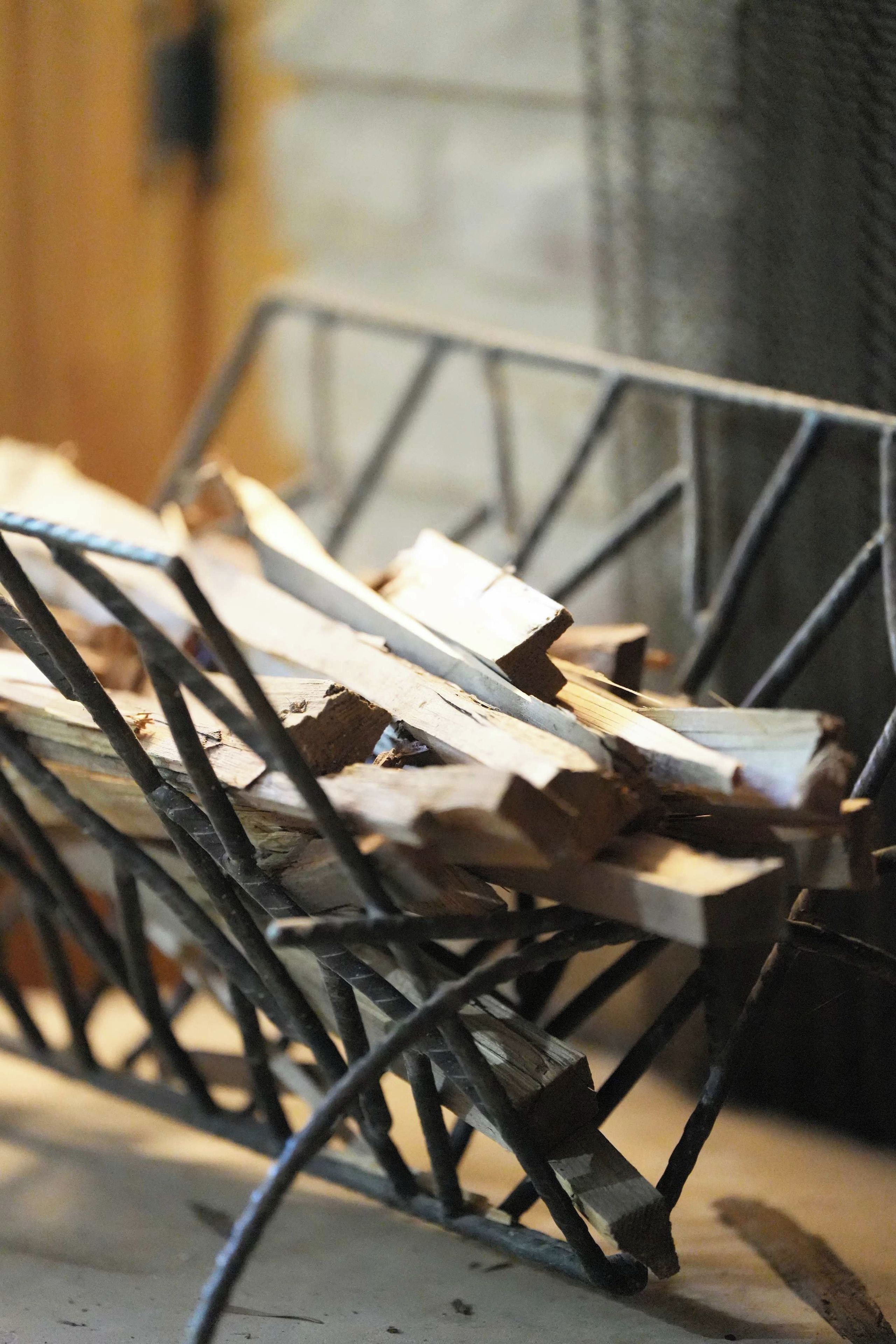 A metal rack holding several pieces of wood.