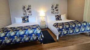 A hotel room with two beds, a nightstand, a lamp, and a window with curtains. - Blue Morpho Lodge (Bajos del Toro)