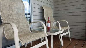 Two wicker chairs with a glass table on a wooden deck. - C&D REST-A-WHILE Book 2 Nights 3rd Is Free 9-1-26 to 9-27-26 Stays Only (Oak Harbor)