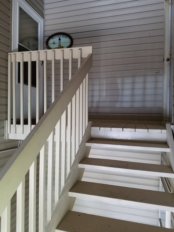 A staircase with white railings leading to a door with a 'Welcome Home' sign above it. - C&D REST-A-WHILE Book 2 Nights 3rd Is Free 9-1-26 to 9-27-26 Stays Only (Oak Harbor)