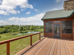 A wooden cabin with a deck overlooking a lake and forest. - Welcome to Selah Hills Ranch – a Tranquil, Digital Detox Off-Grid Haven (Agency)
