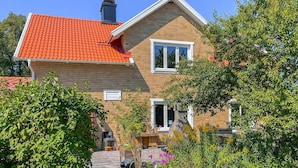 A two-story house with a red-tiled roof, brick walls, and a chimney. - Nice home in Värnamo with sauna (Värnamo)