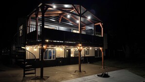 A two-story building with a balcony and a covered outdoor area.