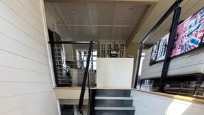 A staircase with a handrail, leading to an upper level.