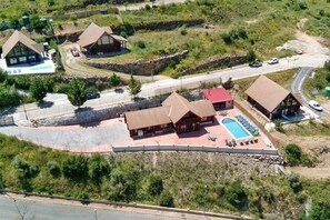 An aerial view of a resort with multiple buildings, a swimming pool, and a parking area. - Nordic-style vacation home on the Costa del Sol—enjoy the Andalusian climate with a pool! (AN)