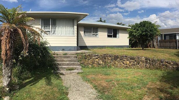 A single-story mobile home with a stone retaining wall and a gravel pathway leading to the front door. - 3 Bedroom House A, 23 Mallard Drive, Rotorua (Rotorua)