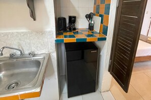 A compact kitchenette with a sink, coffee maker, and a small refrigerator. - 05 Conchi Abajo in Isla Mujeres (Isla Mujeres)