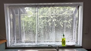 A kitchen with a window, a sink, and a bottle of dish soap. - 5 Bedroom House at Rotorua (Rotorua)