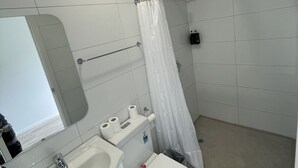 A modern bathroom with a toilet, sink, and shower. - 3 Beds including 1 Double Bed, 2 Single Sofa Beds Garden Chalet, Unit C, 9 Steeles Lane (Rotorua)