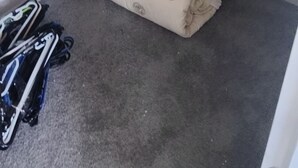 A small, enclosed room with a bed, a wardrobe, and a pair of shoes on the floor. - 5 Beds including 1 Double Bed, 2 single Beds, 2 Double Sofa Beds, Suite 4 (Auckland)