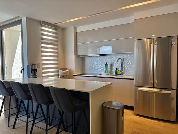 Fridge, microwave, stovetop, coffee/tea maker