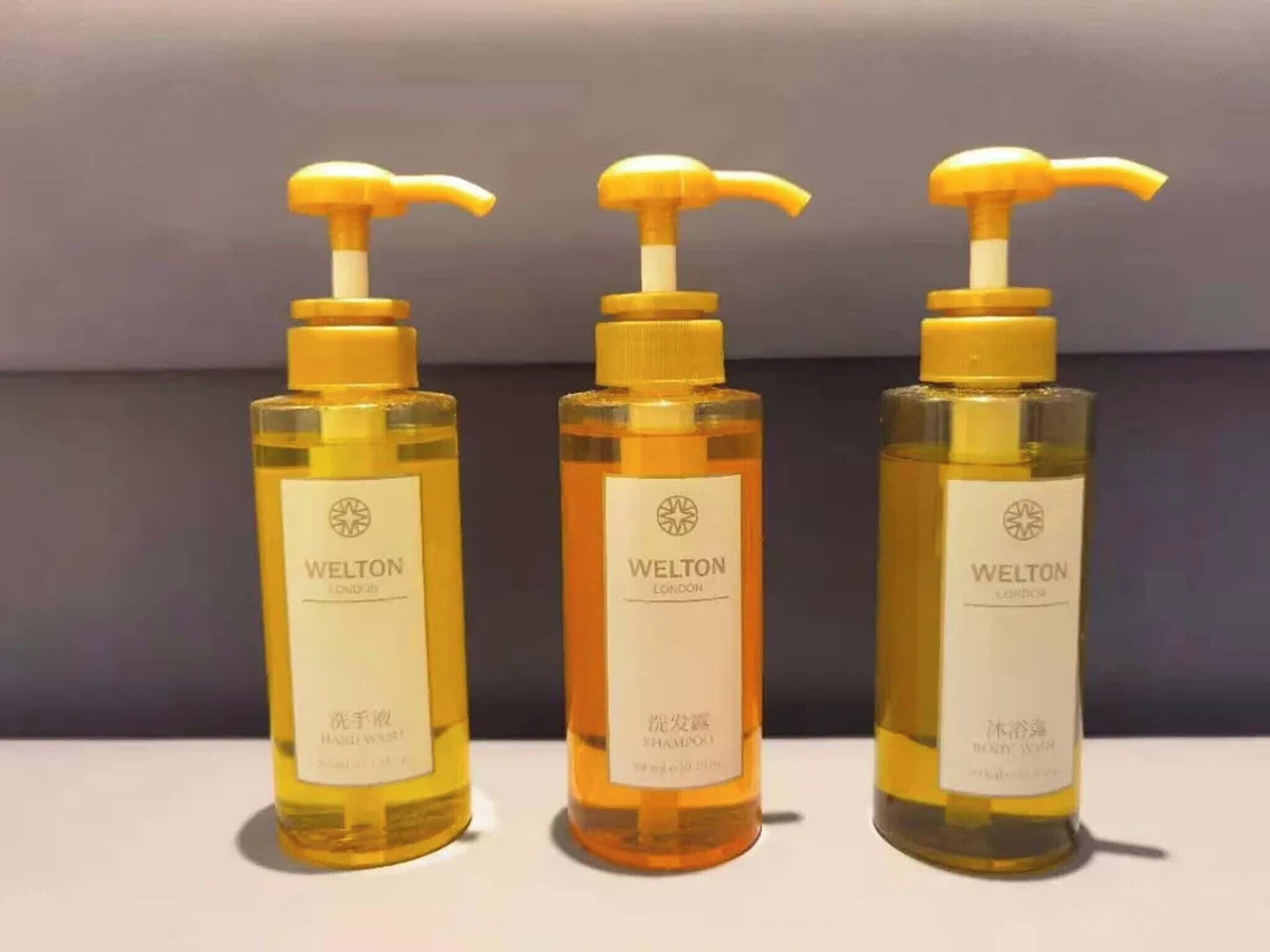 Three bottles of Welton London body wash with pump dispensers.