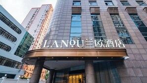 A hotel entrance with a curved facade, large windows, and a prominent sign. - Shanghai Lujiazui BaBaiBan LANOU Hotel (Shanghai)