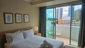 Desk, iron/ironing board, bed sheets