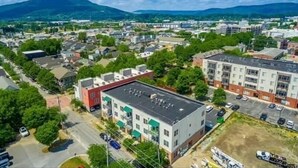 An aerial view of a residential area with multi-story buildings, roads, and greenery. -     Spotless Luxury Retreat. Walk to Food & Fun. King Bed. Free Parking (Chattanooga)