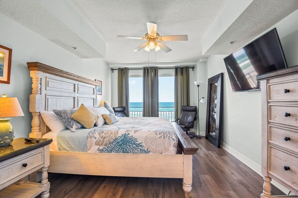 A bedroom with a bed, a ceiling fan, a TV, and a view of the ocean. - Stunning Ocean Views and Sunrise!!
OPUS CONDO-DIRECT OCEANFRONT UNIT# 304 (Daytona Beach Shores)