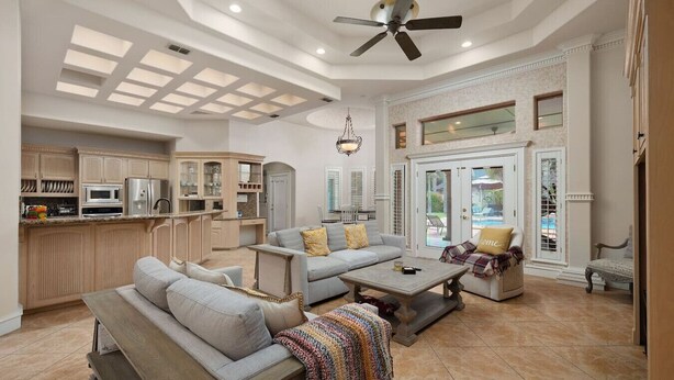 A spacious living area with a kitchen, a dining area, and a patio with a pool view. - Valley Gateaway! Pool House (Mission)