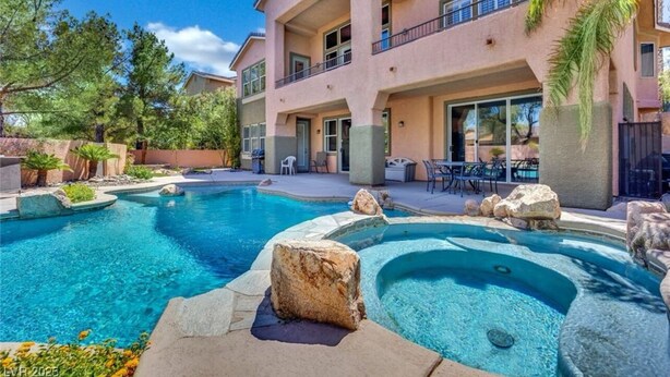 A hotel with a swimming pool, outdoor seating, and a two-story building. - Golden Hour Estate-Pool/jacuzzi/Gated/Lux (Las Vegas)