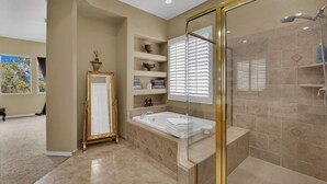 A modern bathroom with a walk-in shower, a freestanding bathtub, and built-in shelves. - Golden Hour Estate-Pool/jacuzzi/Gated/Lux (Las Vegas)