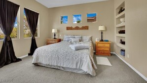 A bedroom with a large bed, two bedside tables, a dresser, and a window with curtains. - Golden Hour Estate-Pool/jacuzzi/Gated/Lux (Las Vegas)