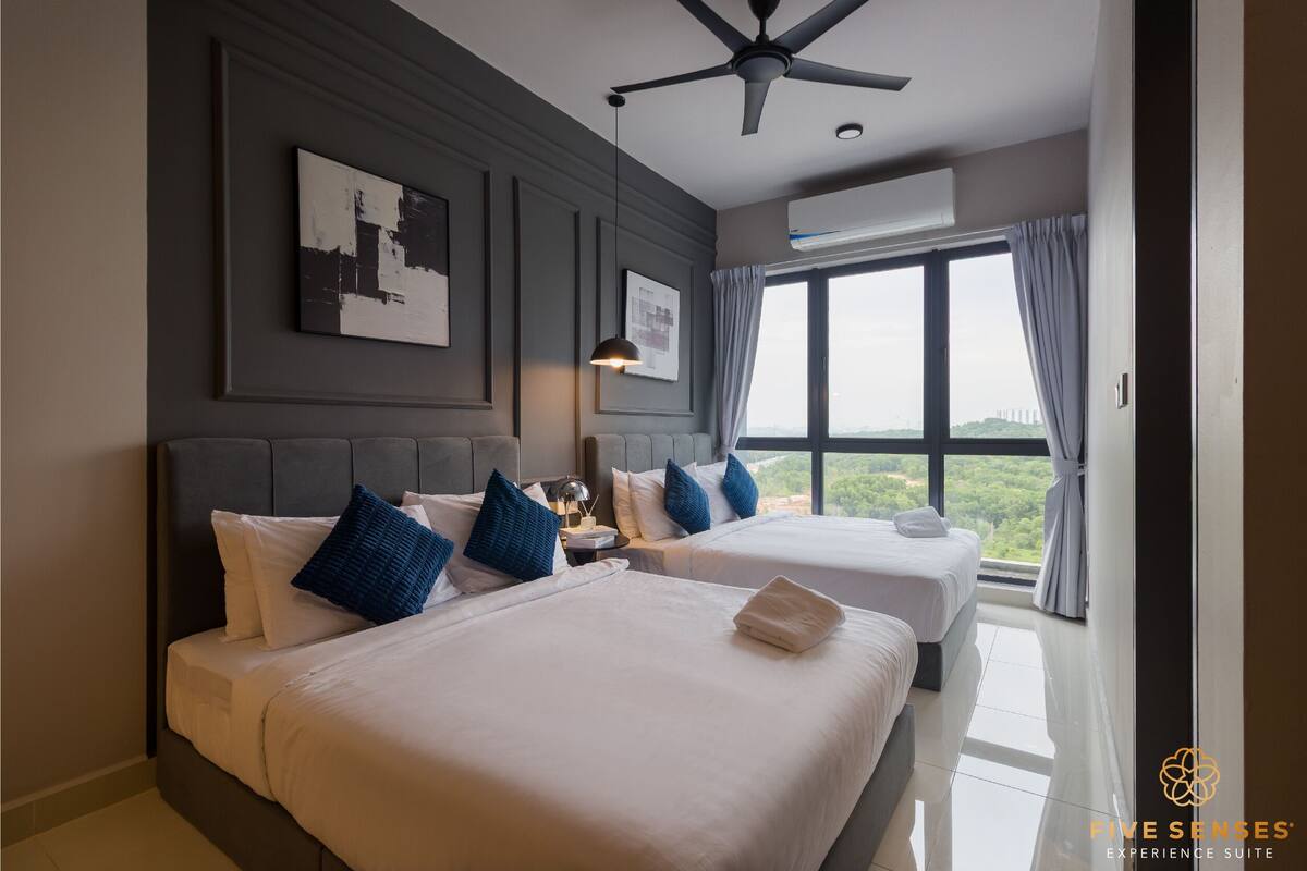 A hotel room with two beds, a ceiling fan, an air conditioning unit, and a large window with curtains.