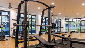 A gym with various exercise equipment, large windows, and a wooden floor. - KIP Core Soho Suite by Five Senses (Sepang)