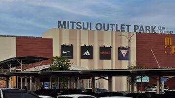 A parking area with cars and a building labeled "MITSUI OUTLET PARK."