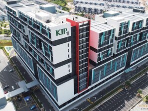 A modern multi-story building with a prominent red and white facade, labeled "KIP." - KIP Core Soho Suite by Five Senses (Sepang)