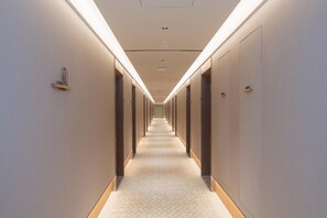 A long, narrow hallway with a patterned carpet and recessed lighting. - Ji Hotel Guangzhou Baiyun Station Sanyuanli Avenue (Guangzhou)