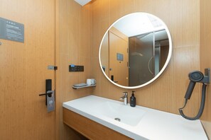 A modern bathroom with a wooden vanity, a round mirror, a hairdryer, and a sign indicating a quiet room. - Ji Guangzhou Beijing Road Tuanyida Square (Guangzhou)