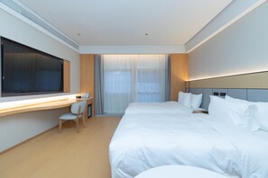 A modern hotel room with a large bed, a desk with a chair, and a large window with curtains. - Ji Guangzhou Beijing Road Tuanyida Square (Guangzhou)