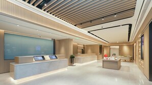 A modern hotel lobby with a reception desk, a seating area, and a large glass wall. - Ji Guangzhou Beijing Road Tuanyida Square (Guangzhou)