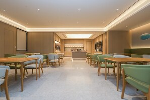 Un moderno vestíbulo de hotel con una zona de bar central, espacios de descanso y un piso pulido.