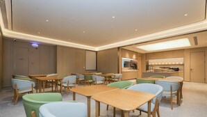 A modern hotel room with a kitchen area, wooden furniture, and a ceiling with recessed lighting. - Ji Guangzhou Beijing Road Tuanyida Square (Guangzhou)