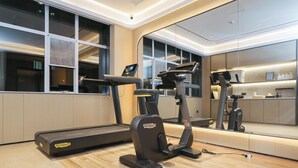 A modern gym with a treadmill, elliptical, and a stationary bike. - Ji Guangzhou Beijing Road Tuanyida Square (Guangzhou)