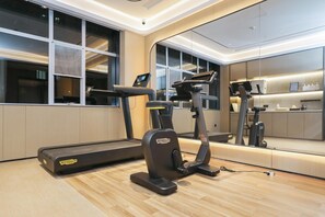 A modern gym with a treadmill, elliptical, and a stationary bike. - Ji Guangzhou Beijing Road Tuanyida Square (Guangzhou)
