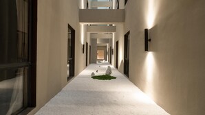 A corridor with a central pathway, flanked by doors and windows, leading to a higher level. - Ji Guangzhou Liwan TCL Yunfeng Technology Park (Guangzhou)